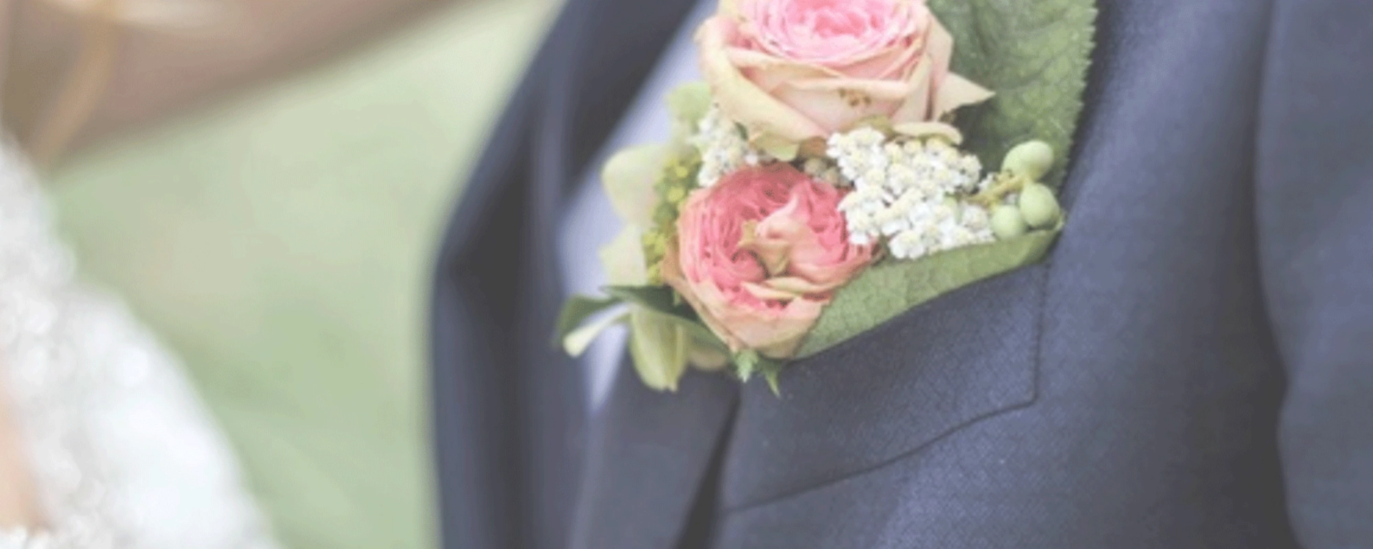 Bride with groom wearing a button corsage